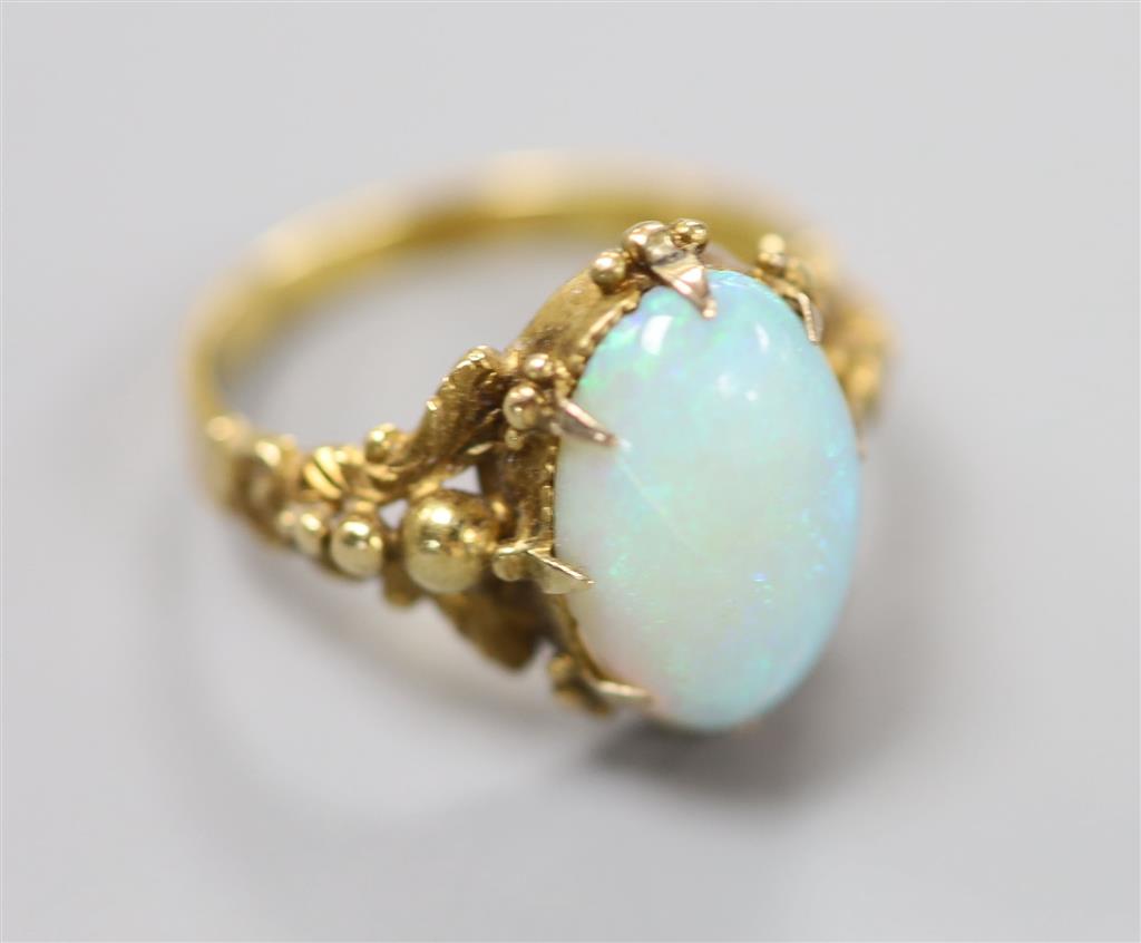 A 19th century yellow metal and oval white opal set dress ring, size M, gross 4.1 grams.